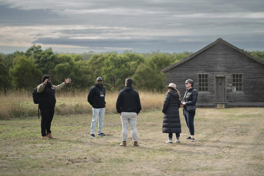 Yoorrook staff hearing truths in front of old mission building at Lake Condah mission
